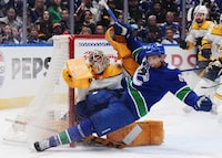 Vancouver Canucks' Dakota Joshua (81) collides with Nashville Predators goalie Juuse Saros during the third period in Game 2 of an NHL hockey Stanley Cup first-round playoff series, in Vancouver, on Tuesday, April 23, 2024. THE CANADIAN PRESS/Darryl Dyck