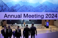 People at the Congress Center where the World Economy Forum take place in Davos, Switzerland, Sunday, Jan. 14, 2024. The annual meeting of the World Economic Forum is taking place in Davos from Jan. 15 until Jan. 19, 2024. (AP Photo/Markus Schreiber)