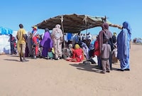 Sudanese refugees gather outside a field hospital in Acre, Chad, Aug. 15, 2023. Canada's former ambassador to Sudan says Ottawa should help steer a global effort to end a brutal civil war that has displaced far more people than wars in Ukraine and the Middle East. THE CANADIAN PRESS/AP Photo