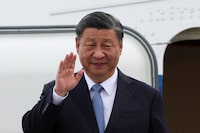 Chinese President Xi Jinping waves as he arrives at San Francisco International Airport to attend the APEC (Asia-Pacific Economic Cooperation) Summit in San Francisco on Nov. 14.