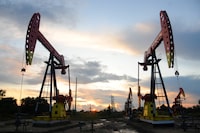 FILE PHOTO: Pumpjacks are seen during sunset at the Daqing oil field in Heilongjiang province, China August 22, 2019. Picture taken August 22, 2019.  REUTERS/Stringer/File Photo