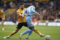 Wolverhampton Wanderers' Max Kilman, left and Coventry City's Haji Wright vie for the ball, during the English FA Cup quarter final match soccer match between Wolverhampton and Coventry City,  at the Molineux, Wolverhampton, England, Saturday, March 16, 2024. (Mike Egerton/PA via AP)
