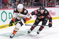 Feb 15, 2024; Ottawa, Ontario, CAN; Anaheim Ducks center Ryan Strome (16) and Ottawa Senators defenseman Maxence Guenette (50) chase the puck in the second period at the Canadian Tire Centre. Mandatory Credit: Marc DesRosiers-USA TODAY Sports