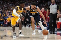Denver Nuggets guard Jamal Murray (27) drives as Los Angeles Lakers guard Dennis Schroder defends during the second half of Game 2 of the NBA basketball Western Conference Finals series, Thursday, May 18, 2023, in Denver. (AP Photo/Jack Dempsey)