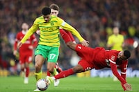 LIVERPOOL, ENGLAND - JANUARY 28: Gabriel Sara of Norwich City and Ryan Gravenberch of Liverpool battle for the ball during the Emirates FA Cup Fourth Round match between Liverpool and Norwich City at Anfield on January 28, 2024 in Liverpool, England. (Photo by Clive Brunskill/Getty Images)
