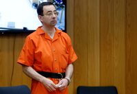 FILE PHOTO: Larry Nassar, a former team USA Gymnastics doctor who pleaded guilty in November 2017 to sexual assault charges, stands in court during his sentencing hearing in the Eaton County Court in Charlotte, Michigan, U.S., February 5, 2018.  REUTERS/Rebecca Cook/File Photo