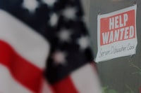 FILE PHOTO: A “Help Wanted” sign hangs in restaurant window in Medford, Massachusetts, U.S., January 25, 2023. REUTERS/Brian Snyder/File Photo
