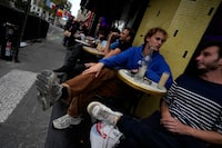 People socialize and drink at a cafe terrace, at the Oberkampf district east of Paris, France,, France, Wednesday, Sept. 27, 2023. (AP Photo/Themba Hadebe)