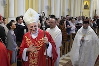 FILE - Cardinal Matteo Zuppi, head of the CEI (Italian Conference of Bishops), welcomes parishioners after celebrating Mass at the Cathedral of the Immaculate Conception in Moscow, Thursday, June 29, 2023. Pope Francis’ peace envoy was travelling to Washington on Monday, July 17 in hopes of promoting peace initiatives for Ukraine and supporting humanitarian operations, especially concerning children, the Vatican said. Cardinal Matteo Zuppi’s visit, which lasts through Wednesday, follows his recent mission to Moscow and an earlier stop in Kyiv, where he met with President Volodymyr Zelenskyy. (AP Photo/Alexander Zemlianichenko, file)