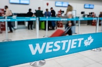 A line at the WestJet counter at the airport in Calgary, Alta., Thursday, May 18, 2023. THE CANADIAN PRESS/Jeff McIntosh