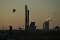 (FILES) A balloon flies above the coal-fired power station 'Scholven' in Gelsenkirchen, western Germany, on April 10, 2024. G7 energy ministers are close to committing to a common target of shutting down their coal-fired power plants "in the first half of the 2030s", a source told AFP on April 29, 2024. The meeting of the seven leading industrialised nations in Turin is the first big political session since the world pledged at the UN's COP28 climate summit in December to transition away from coal, oil and gas. (Photo by Ina FASSBENDER / AFP) (Photo by INA FASSBENDER/AFP via Getty Images)