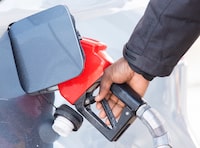 Canadians living in provinces where the federal carbon tax is collected are expected to receive their first Climate Action Incentive rebate today. A man pumps gas in Montreal, Friday, March 4, 2022. THE CANADIAN PRESS/Graham Hughes