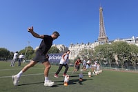 PARIS, FRANCE - SEPTEMBER 07: Rugby legend and Mastercard ambassador Dan Carter ‘kicks off’ the Rugby World Cup 2023 tournament with French kids, against an iconic Parisian backdrop on September 07, 2023 in Paris, France. (Photo by Pierre Suu/Getty Images for Mastercard)
