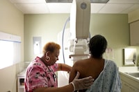 In this file image, Betty Daniel of Chicago gets her routine yearly mammogram from Lead Mammography Tech Stella Palmer at Mt. Sinai Hospital in Chicago on Wednesday, Feb. 15, 2012. The challenges COVID-19 presents are even greater for people who are already grappling with a serious illness, like cancer. (Heather Charles/Chicago Tribune/Tribune News Service via Getty Images)