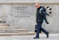 A person walks past the Bank of Canada, Wednesday, April 10, 2024 in Ottawa.  THE CANADIAN PRESS/Adrian Wyld