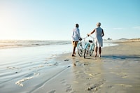 Shot of a senior couple riding their bicycles at the beach