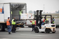 Workers transport the second shipment of the Johnson & Johnson Covid-19 coronavirus vaccine upon its arrival at the O R Tambo International Airport in Johannesburg on February 27, 2021. (Photo by Kim LUDBROOK / POOL / AFP) (Photo by KIM LUDBROOK/POOL/AFP via Getty Images)