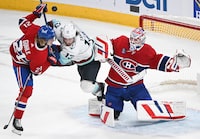 Seattle Kraken's Brandon Tanev (13) moves in on Montreal Canadiens goaltender Sam Montembeault as Canadiens' Kaiden Guhle (21) defends during third period NHL hockey action in Montreal, Monday, December 4, 2023. THE CANADIAN PRESS/Graham Hughes