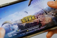 FILE PHOTO: FILE PHOTO: "Game for Peace", Tencent's alternative to the blockbuster video game "PlayerUnknown's Battlegrounds" (PUBG) in China, is seen on a mobile phone in this illustration picture taken May 13, 2019.  REUTERS/Florence Lo/Illustration/File Photo