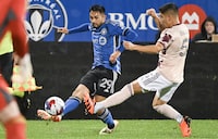 CF Montreal's Mathieu Choiniere (29) plays a pass as Portland Timbers' Claudio Bravo defends during first half MLS soccer action in Montreal, Saturday, October 7, 2023. THE CANADIAN PRESS/Graham Hughes
