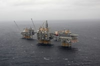 (FILES) In this file photo taken on December 03, 2019 an aerial view taken from an helicopter during a media visit shows five platforms over the Johan Sverdrup oil field in the North Sea some 140 kilometres west of the town of Stavanger, Norway. - The Covid-19 pandemic and the fall in oil prices that it has caused has generated monumental losses among the oil giants, forced to tighten their belts and in particular to brutally curb their exploration and drilling activities. In the North Sea, drilling activity has been cut by 70% in the UK and 30% in Norway compared to pre-crisis plans, according to a study by energy research firm Westwood released late September. "Oil exploration has taken a big hit this year with the collapse in demand and oil prices due to the global pandemic," PVM analyst Stephen Brennock told AFP. (Photo by Tom LITTLE / AFP) (Photo by TOM LITTLE/AFP via Getty Images)