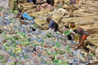 FILE - Pakistani laborers, mostly women, sort through empty bottles at a plastic recycling factory in Hyderabad, Pakistan, April 30, 2023. (AP Photo/Pervez Masih, File)