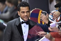 (FILES) Brazil and FC Barcelona defender Dani Alves poses on the red carpet as he arrives for the 2015 FIFA Ballon d'Or award ceremony at the Kongresshaus in Zurich on January 11, 2016. A Spanish court on February 22, 2024 sentenced former Brazil international Dani Alves to four and a half years in prison after finding him guilty of raping a young woman at a Barcelona nightclub in December 2022. (Photo by MICHAEL BUHOLZER / AFP) (Photo by MICHAEL BUHOLZER/AFP via Getty Images)