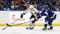 Chicago Blackhawks right wing Corey Perry (94) gets around Tampa Bay Lightning defenseman Victor Hedman (77) during the third period of an NHL hockey game Thursday, Nov. 9, 2023, in Tampa, Fla. (AP Photo/Chris O'Meara)