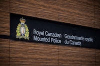 The RCMP logo is seen outside Royal Canadian Mounted Police "E" Division Headquarters, in Surrey, B.C., on Friday April 13, 2018. Police in British Columbia's Interior are asking for the public's help to identify a suspect vehicle after a man was fatally shot this weekend. THE CANADIAN PRESS/Darryl Dyck