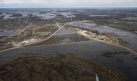 Peguis First Nation is shown with surrounded with Fisher River flood water north of Winnipeg, Sunday, May 15, 2022. A Manitoba First Nation that has suffered from chronic flooding is suing three levels of government for $1 billion. THE CANADIAN PRESS/John Woods
