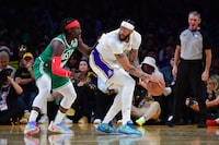 Dec 25, 2023; Los Angeles, California, USA; Los Angeles Lakers forward Anthony Davis (3) controls the ball against Boston Celtics guard Jrue Holiday (4) during the second half at Crypto.com Arena. Mandatory Credit: Gary A. Vasquez-USA TODAY Sports