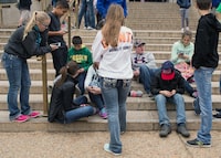(FILES) In this file photo taken on April 8, 2015  a group of teens check their smart phones outside the Natural History Museum in Washington,DC. - American teenagers remain generally upbeat about social media, saying it helps them feel included and connected, despite persistent problems of social pressure and bullying, a study showed November 28, 2018. The Pew Research Center report found a strong majority of the 13- to 17-year-olds had positive rather than negative feelings about their social media experiences. (Photo by Nicholas KAMM / AFP)NICHOLAS KAMM/AFP/Getty Images