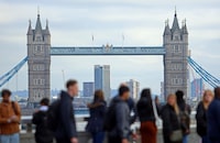 FILE PHOTO: People walk over London Bridge looking at a view of Tower Bridge in the City of London financial district in London, Britain, October 25, 2023. REUTERS/ Susannah Ireland/File Photo