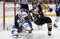 Pittsburgh Penguins' Bryan Rust, right, and Winnipeg Jets' Brenden Dillon collide during the second period of an NHL hockey game in Pittsburgh, Friday, Jan. 13, 2023. (AP Photo/Gene J. Puskar)