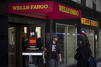 FILE PHOTO: People exit and enter Wells Fargo ATM in the Manhattan borough of New York, October 10, 2015.  REUTERS/Eduardo Munoz/File Photo