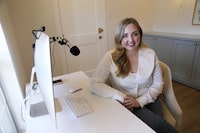 Paige Pritchard, a spending coach who shares financial advice on TikTok, poses for a photo in her home office, Thursday, Feb. 9, 2023, in Coppell, Texas. At a time when consumers are inundated with so-called social media influencers peddling the latest products online, a slew of TikTok users are leveraging their platforms to tell people what not to buy instead. Pritchard said she chose her career path after blowing her entire $60,000 salary on clothing, beauty and hair products in the first year after she graduated from college. (AP Photo/Tony Gutierrez)