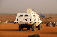 (FILES) In this file photo taken on March 14, 2020 A United Nation armoured vehicle with the MINUSMA, the United Nations Multidimensional Integrated Stabilisation Mission in Mali, patrols in the desert outside Menaka during the congress of the Movement for the Salvation of Azawad (MSA) a Tuareg political and armed movement in the Azawad Region in Mali. - Three United Nations peacekeepers were killed and five were seriously injured on February 21, 2023 when their convoy struck a roadside bomb in central Mali, the UN mission said. (Photo by Souleymane Ag Anara / AFP) (Photo by SOULEYMANE AG ANARA/AFP via Getty Images)