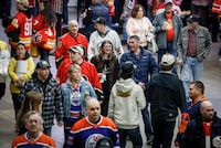 Crowds walk through the concourse before the start of a Calgary Flames game in Calgary, Saturday, April 6, 2024.THE CANADIAN PRESS/Jeff McIntosh