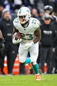 Miami Dolphins running back Jeff Wilson Jr. (23) runs with the ball after catching a pass during the second half of an NFL football game against the Baltimore Ravens, Sunday, Dec. 31, 2023, in Baltimore. (AP Photo/Terrance Williams)
