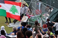 Demonstrators break down fences to re-occupy an encampment in support of Palestinians at the Massachusetts Institute of Technology (MIT), during the ongoing conflict between Israel and the Palestinian Islamist group Hamas, in Cambridge, Massachusetts, U.S., May 6, 2024. REUTERS/Brian Snyder