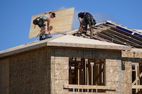 Builders work on the roof of a home in a new subdivision in the Ottawa suburb of Kanata, on Friday, July 30, 2021. THE CANADIAN PRESS/Justin Tang