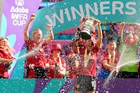 Manchester United players spray team captain Katie Zelem lifting the trophy after winning the Women's FA Cup final soccer match between Manchester United and Tottenham Hotspur at Wembley Stadium in London, Sunday, May 12, 2024. Manchester United won 4-0. (AP Photo/Kirsty Wigglesworth)