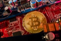 A representation of cryptocurrency Bitcoin is placed on a PC motherboard, in this illustration taken June 16..