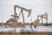 An array of pumpjacks operate in a snowy oil patch on Thursday, Feb. 3, 2022 in Midland, Texas. A major winter storm with millions of Americans in its path is spreading rain, freezing rain and heavy snow further across the country. (Eli Hartman/Odessa American via AP)