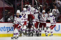 RALEIGH, NORTH CAROLINA - MAY 09: Members of the New York Rangers celebrate after the game winning goal against the Carolina Hurricanes in the first overtime of Game Three of the Second Round of the 2024 Stanley Cup Playoffs at PNC Arena on May 09, 2024 in Raleigh, North Carolina.  (Photo by Bruce Bennett/Getty Images)