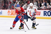 MONTREAL, CANADA - FEBRUARY 17: Cole Caufield #22 of the Montreal Canadiens and Alex Ovechkin #8 of the Washington Capitals skate after the puck during the first period at the Bell Centre on February 17, 2024 in Montreal, Quebec, Canada. (Photo by Minas Panagiotakis/Getty Images)