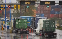 Trucks line up to get into the Port Of Metro Vancouver October 15, 2014. The Port Metro Vancouver is reducing the number of licences for transport drivers conducting business there by at least 25 per cent. There are currently 2,000 trucks registered with the Port.  (John Lehmann/The Globe and Mail) 