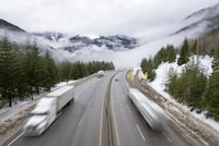 Heavy snowfall and winter storm conditions have shut down high-elevation stretches of a pair of major highways in the British Columbia Interior. Vehicles drive along the Coquihalla Highway, Wednesday, Jan. 19, 2022. THE CANADIAN PRESS/Jonathan Hayward