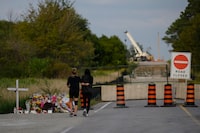 Friends and family visit a memorial near the site of an accident that killed six young  people in Barrie, Ont. on Saturday, September 3, 2022. Police have charged a construction company in connection to a fatal crash in Barrie, Ont., that killed six young people in September.THE CANADIAN PRESS/Christopher Katsarov