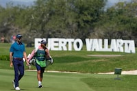 Alvaro Ortiz, of Mexico, left, walks to the first tee during the second round of the Mexico Open golf tournament in Puerto Vallarta, Mexico, Friday, Feb. 23, 2024. (AP Photo/Fernando Llano)